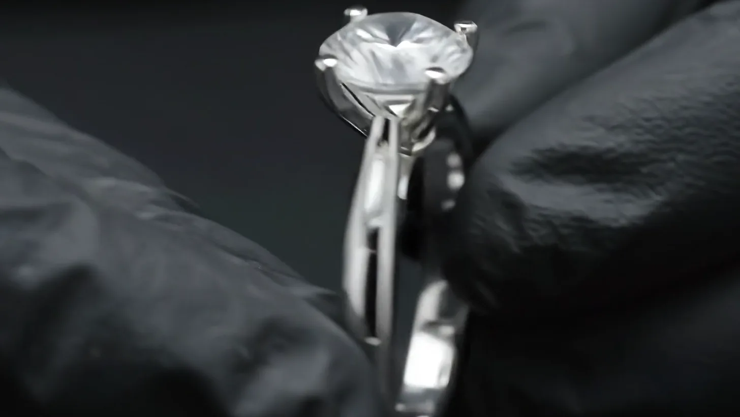 The set ring turned in gloved fingers for inspection