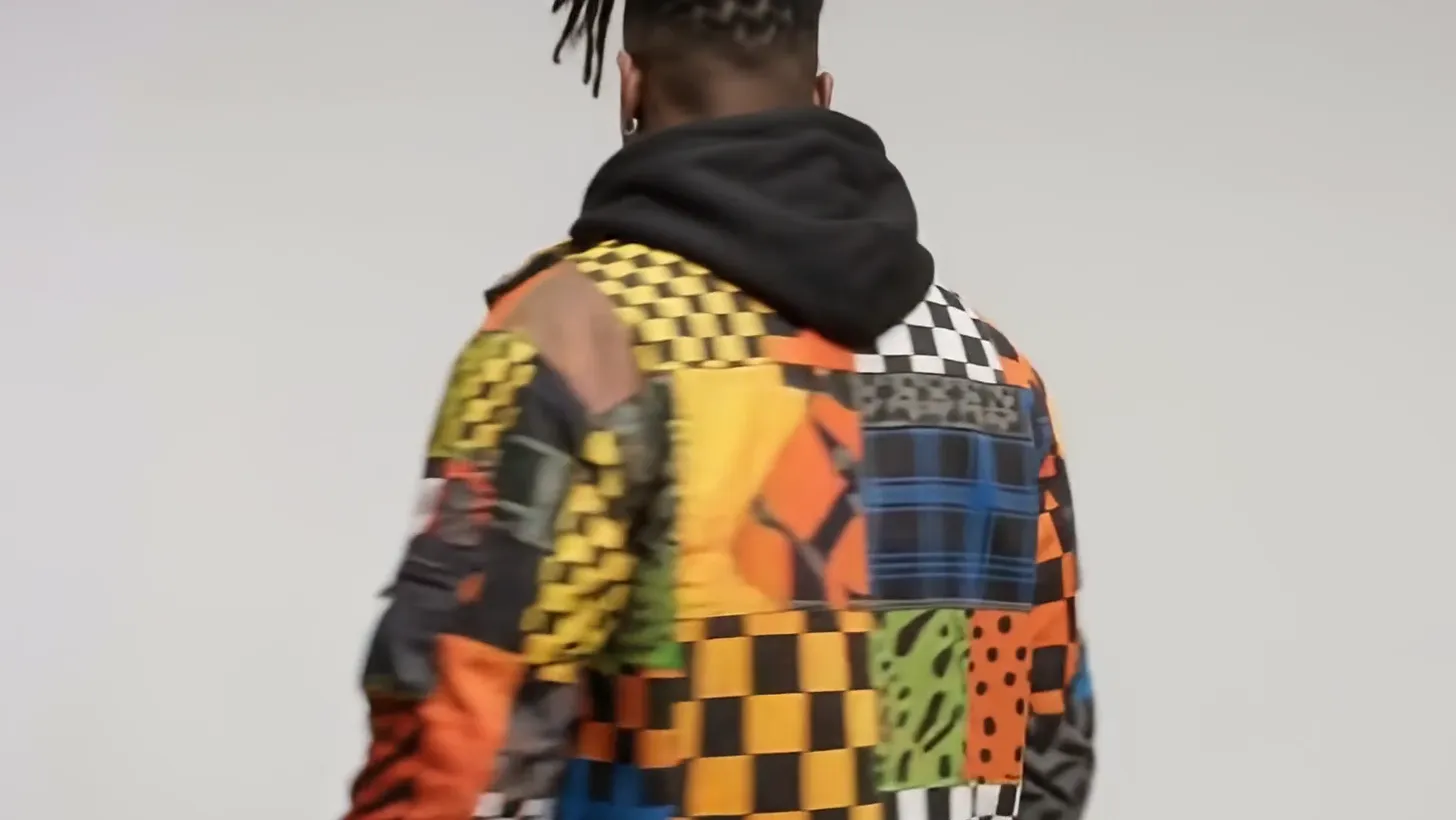 The back of the jacket: blue plaid, orange and checker panels under a black hood